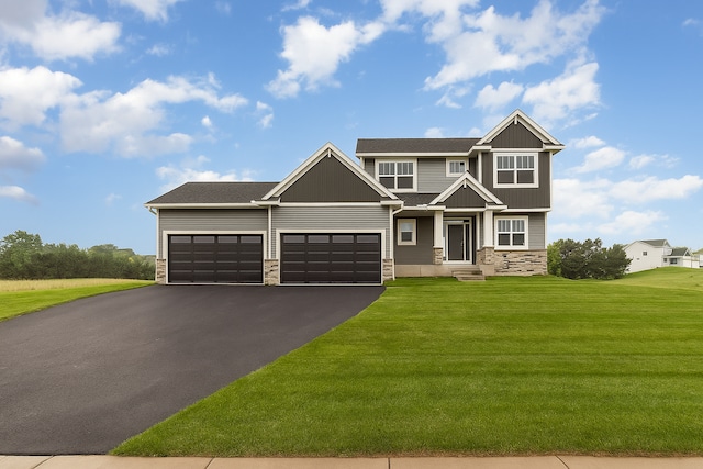 20610 Redwood St NW, Oak Grove, MN 55011 - craftsman inspired home with stone siding, an attached garage, driveway, a front lawn, and board and batten siding