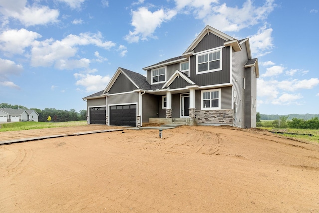 20610 Redwood St NW, Oak Grove, MN 55011 - craftsman house featuring stone siding, a garage, board and batten siding, and dirt driveway