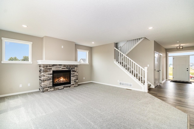 20610 Redwood St NW, Oak Grove, MN 55011 - unfurnished living room with stairs, a fireplace, carpet, recessed lighting, and wood finished floors