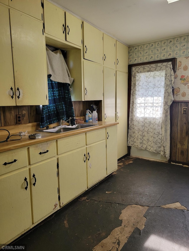 203 Ann Ave E, Clarissa, MN 56440 - kitchen featuring cream cabinets, a sink, and wallpapered walls
