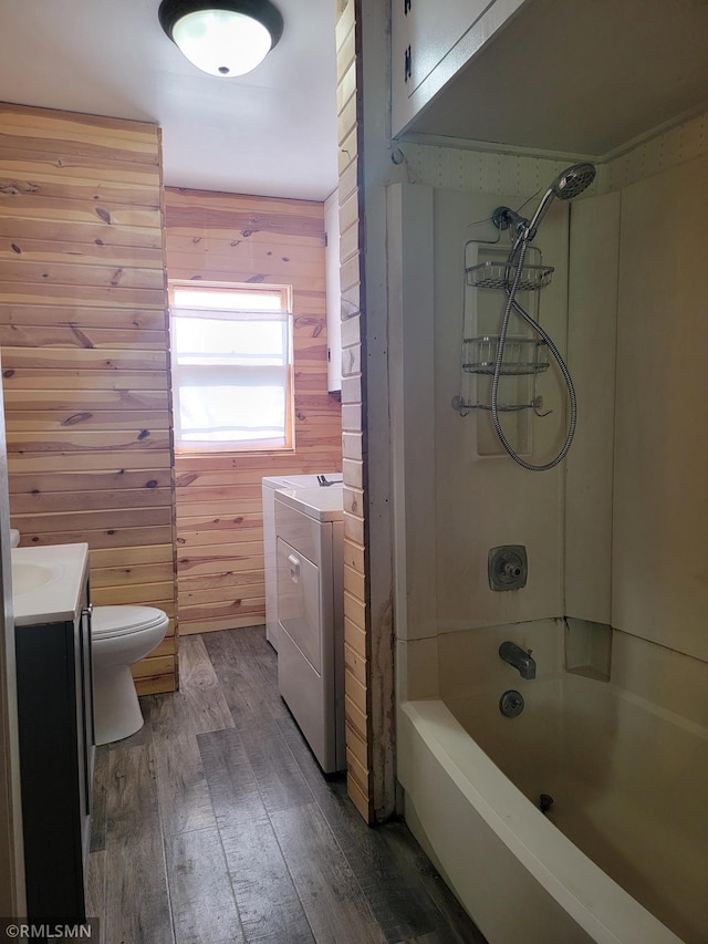 203 Ann Ave E, Clarissa, MN 56440 - bathroom with washing machine and dryer, vanity, wooden walls, wood-type flooring, and toilet