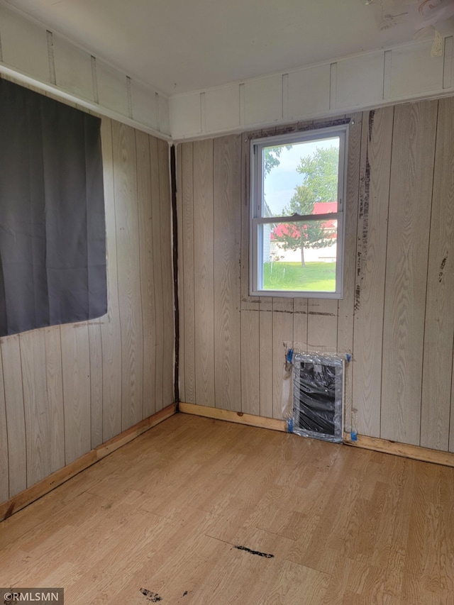 203 Ann Ave E, Clarissa, MN 56440 - unfurnished room featuring wood finished floors, heating unit, and wood walls