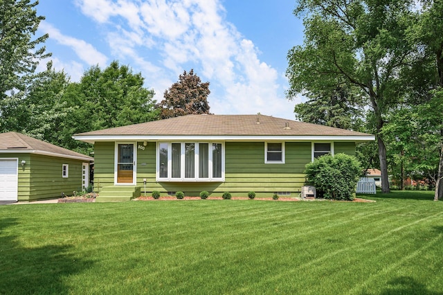 800 82nd Ave N, Brooklyn Park, MN 55444 - back of house with entry steps, a lawn, and a garage