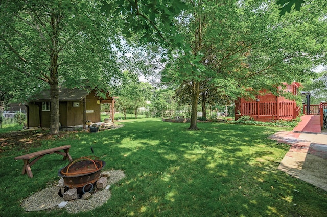 800 82nd Ave N, Brooklyn Park, MN 55444 - view of yard with an outdoor fire pit, an outbuilding, and a deck