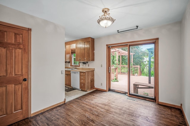 800 82nd Ave N, Brooklyn Park, MN 55444 - kitchen with white dishwasher, wood finished floors, brown cabinets, and light countertops
