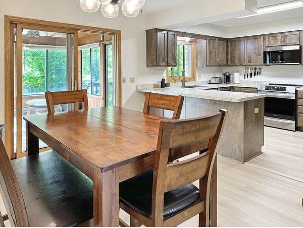 861 Lake Susan Dr, Chanhassen, MN 55317 - dining room with light wood-type flooring and a chandelier
