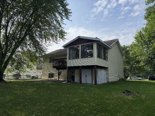 861 Lake Susan Dr, Chanhassen, MN 55317 - back of house with a yard, a sunroom, a garage, and a wooden deck