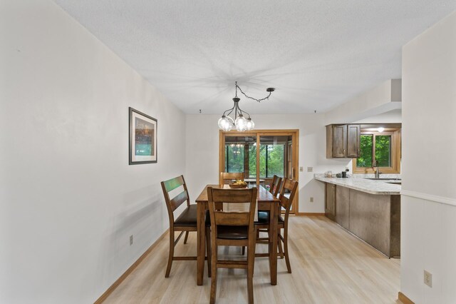 861 Lake Susan Dr, Chanhassen, MN 55317 - dining area featuring light wood-style floors, a chandelier, and a textured ceiling