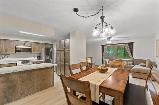861 Lake Susan Dr, Chanhassen, MN 55317 - dining room with light wood-style flooring and a ceiling fan