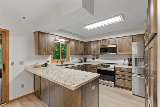 861 Lake Susan Dr, Chanhassen, MN 55317 - kitchen with appliances with stainless steel finishes, a peninsula, light wood-style floors, and light countertops