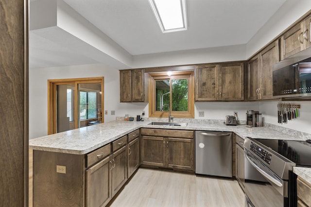 861 Lake Susan Dr, Chanhassen, MN 55317 - kitchen featuring appliances with stainless steel finishes, a peninsula, light countertops, and healthy amount of natural light