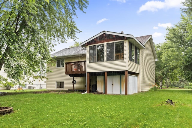 861 Lake Susan Dr, Chanhassen, MN 55317 - rear view of property featuring roof with shingles, a yard, a sunroom, and a wooden deck