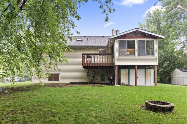 861 Lake Susan Dr, Chanhassen, MN 55317 - back of house with a fire pit, a yard, a shed, a wooden deck, and roof with shingles