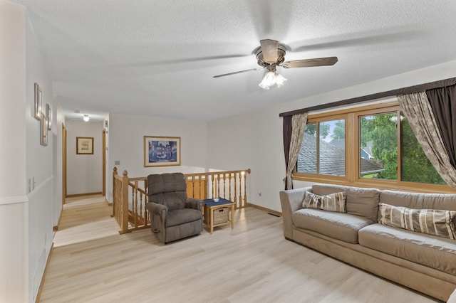 861 Lake Susan Dr, Chanhassen, MN 55317 - living area with light wood-type flooring, a textured ceiling, and a ceiling fan