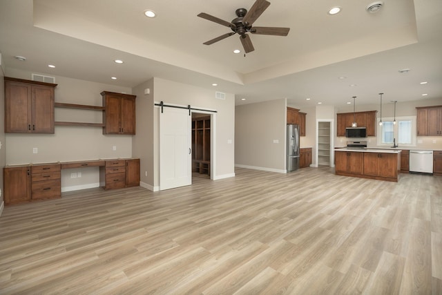 1202 15th St NE, Kasson, MN 55944 - kitchen with dishwasher, a barn door, stainless steel fridge with ice dispenser, open floor plan, and recessed lighting