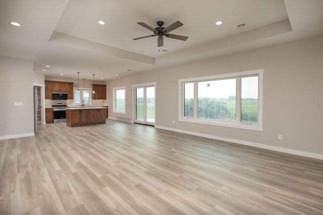 1202 15th St NE, Kasson, MN 55944 - unfurnished living room featuring recessed lighting, baseboards, light wood-type flooring, and a ceiling fan