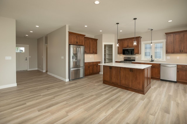 1202 15th St NE, Kasson, MN 55944 - kitchen with appliances with stainless steel finishes, light countertops, light wood finished floors, recessed lighting, and a center island