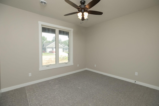 1202 15th St NE, Kasson, MN 55944 - spare room with dark colored carpet, ceiling fan, and baseboards