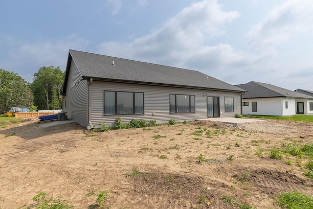 1202 15th St NE, Kasson, MN 55944 - back of property featuring a patio, central AC, and roof with shingles