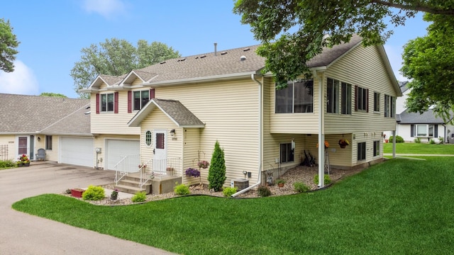3726 Gershwin Ln N, Oakdale, MN 55128 - view of front facade with concrete driveway, a front lawn, an attached garage, and roof with shingles