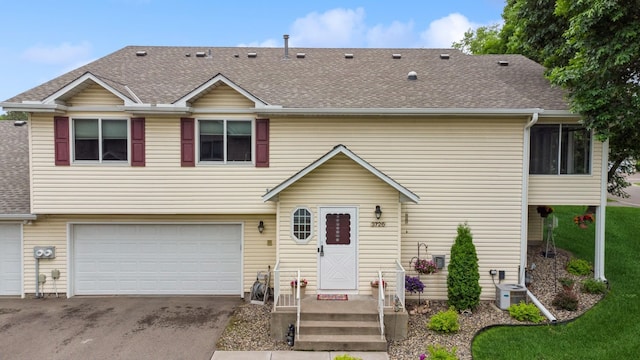 3726 Gershwin Ln N, Oakdale, MN 55128 - view of front facade featuring asphalt driveway, an attached garage, and a shingled roof