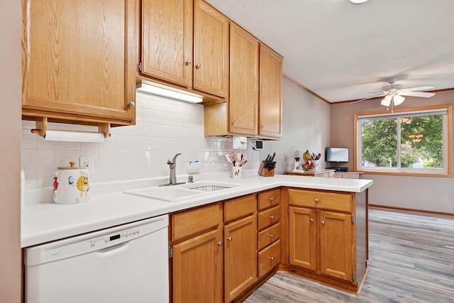 3726 Gershwin Ln N, Oakdale, MN 55128 - kitchen with white dishwasher, light wood-style flooring, a peninsula, a ceiling fan, and tasteful backsplash