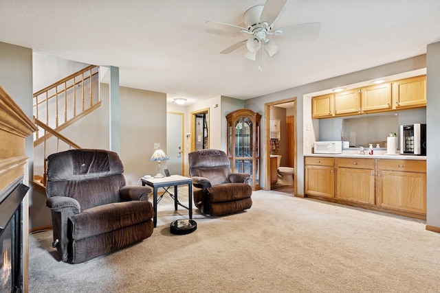 3726 Gershwin Ln N, Oakdale, MN 55128 - carpeted living room with a ceiling fan and stairway