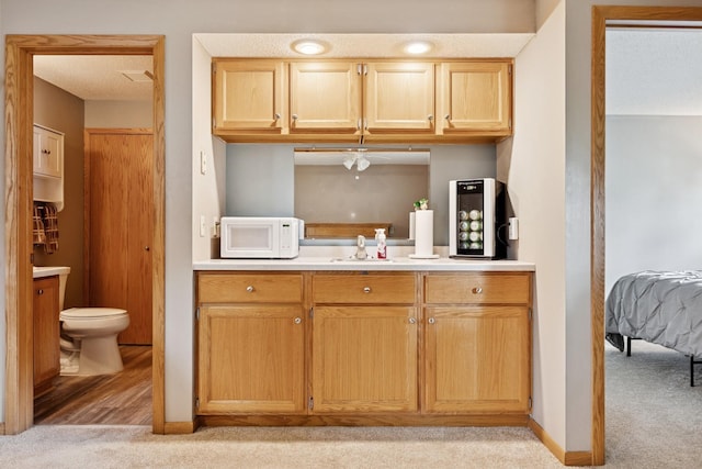 3726 Gershwin Ln N, Oakdale, MN 55128 - kitchen featuring white microwave, light carpet, light countertops, and a ceiling fan
