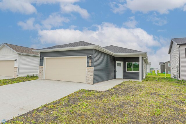 6614 68th St S, Horace, ND 58047 - view of front facade featuring a garage, concrete driveway, and a shingled roof