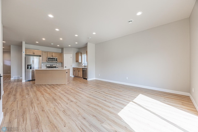 6614 68th St S, Horace, ND 58047 - kitchen featuring stainless steel appliances, open floor plan, a kitchen island, recessed lighting, and light wood-style floors