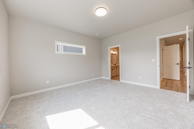 6614 68th St S, Horace, ND 58047 - unfurnished bedroom with light carpet and ensuite bathroom