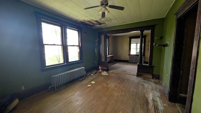 307 10th St S, Wheaton, MN 56296 - spare room featuring radiator heating unit, hardwood / wood-style flooring, and baseboards
