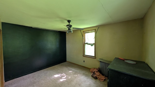 307 10th St S, Wheaton, MN 56296 - carpeted empty room with ceiling fan, baseboards, and radiator