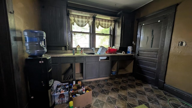 307 10th St S, Wheaton, MN 56296 - kitchen with light countertops, dark tile patterned flooring, and a sink