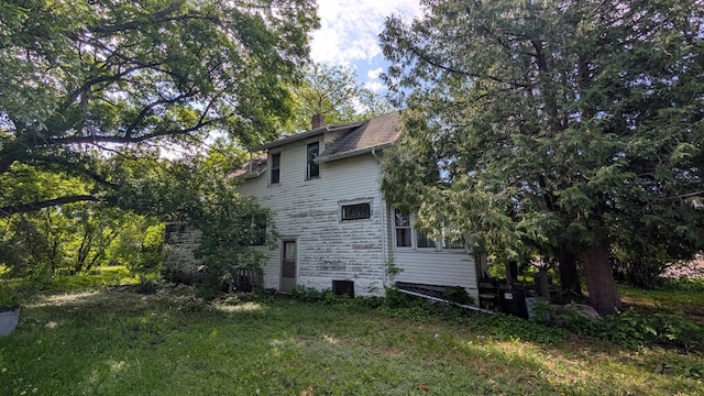307 10th St S, Wheaton, MN 56296 - view of property exterior with a chimney and central air condition unit