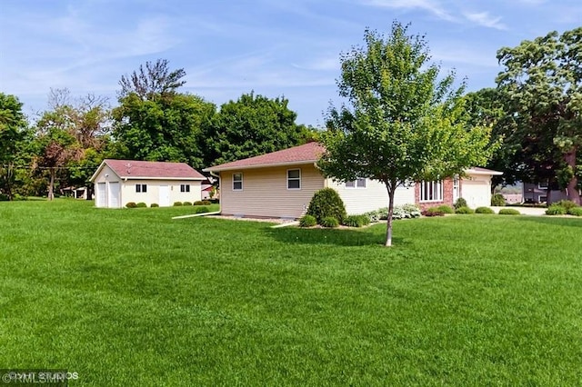 30339 72nd Avenue Way, Cannon Falls, MN 55009 - view of grassy yard with a garage