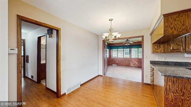 30339 72nd Avenue Way, Cannon Falls, MN 55009 - unfurnished dining area with light wood finished floors, a chandelier, and baseboards