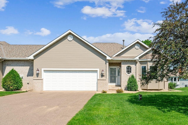917 133rd Ln NE, Ham Lake, MN 55304 - ranch-style house with brick siding, concrete driveway, an attached garage, a front yard, and roof with shingles