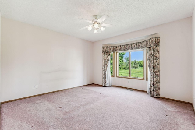 917 133rd Ln NE, Ham Lake, MN 55304 - carpeted spare room featuring a ceiling fan, baseboards, and a textured ceiling