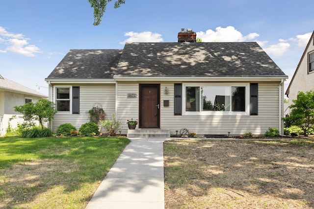4416 Zenith Ave N, Robbinsdale, MN 55422 - cape cod house featuring a chimney, a front yard, and roof with shingles