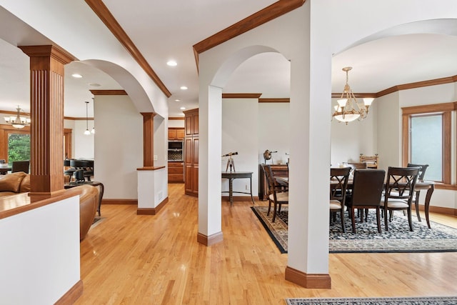 2906 Butternut Dr, Chaska, MN 55318 - dining area with a chandelier, crown molding, light wood-type flooring, ornate columns, and recessed lighting