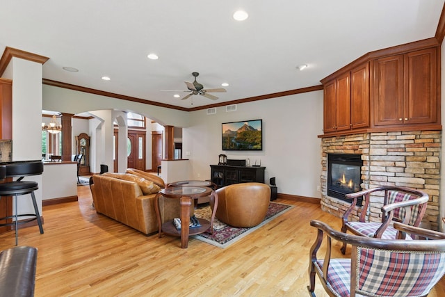 2906 Butternut Dr, Chaska, MN 55318 - living area featuring decorative columns, a fireplace, a ceiling fan, light wood-style floors, and crown molding