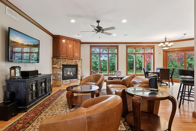 2906 Butternut Dr, Chaska, MN 55318 - living room with ornamental molding, a fireplace, light wood-type flooring, plenty of natural light, and a ceiling fan
