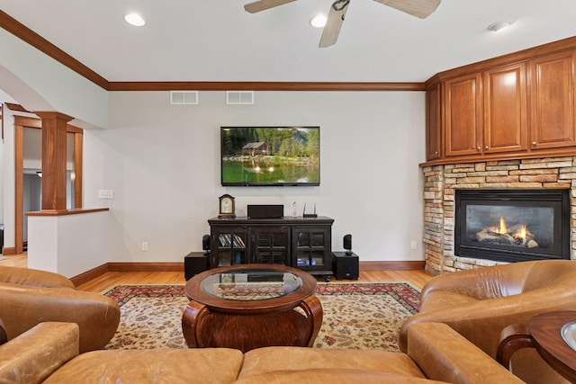 2906 Butternut Dr, Chaska, MN 55318 - living area featuring a stone fireplace, light wood-style flooring, ornamental molding, decorative columns, and ceiling fan