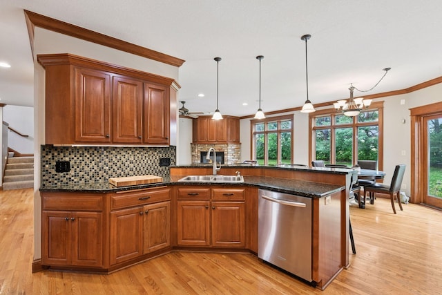 2906 Butternut Dr, Chaska, MN 55318 - kitchen with stainless steel dishwasher, brown cabinets, light wood-style flooring, ornamental molding, and recessed lighting