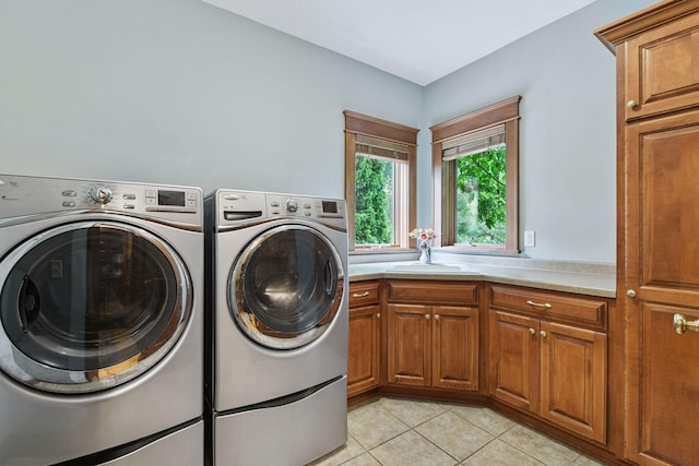 2906 Butternut Dr, Chaska, MN 55318 - laundry area featuring washer and clothes dryer, cabinet space, and light tile patterned flooring