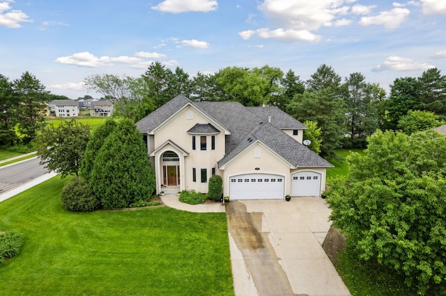 2906 Butternut Dr, Chaska, MN 55318 - view of front of home featuring driveway, a front lawn, a garage, a shingled roof, and stucco siding