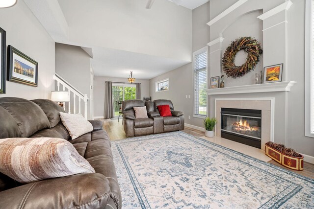 4345 Merrimac Ln N Unit 7, Plymouth, MN 55446 - living area with wood finished floors, a glass covered fireplace, stairs, and baseboards