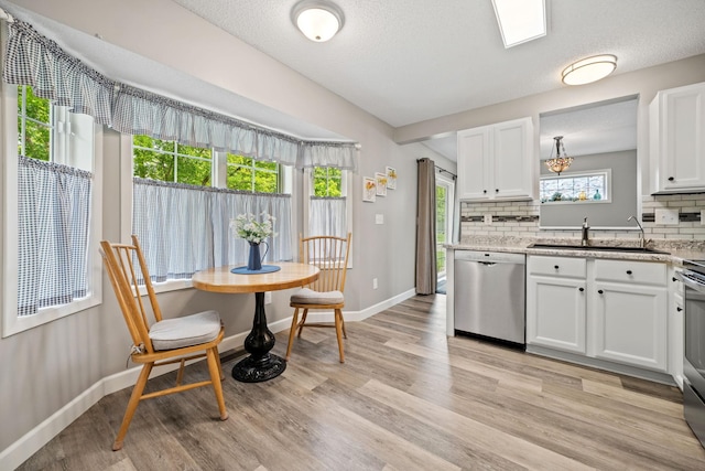 4345 Merrimac Ln N Unit 7, Plymouth, MN 55446 - kitchen featuring dishwasher, a sink, decorative backsplash, light wood-style flooring, and a textured ceiling