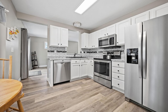 4345 Merrimac Ln N Unit 7, Plymouth, MN 55446 - kitchen with appliances with stainless steel finishes, a sink, white cabinetry, and tasteful backsplash
